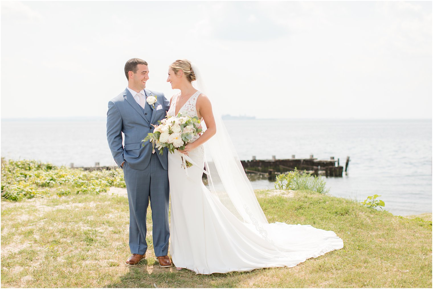 waterfront wedding portraits at Sandy Hook Chapel photographed by Idalia Photography