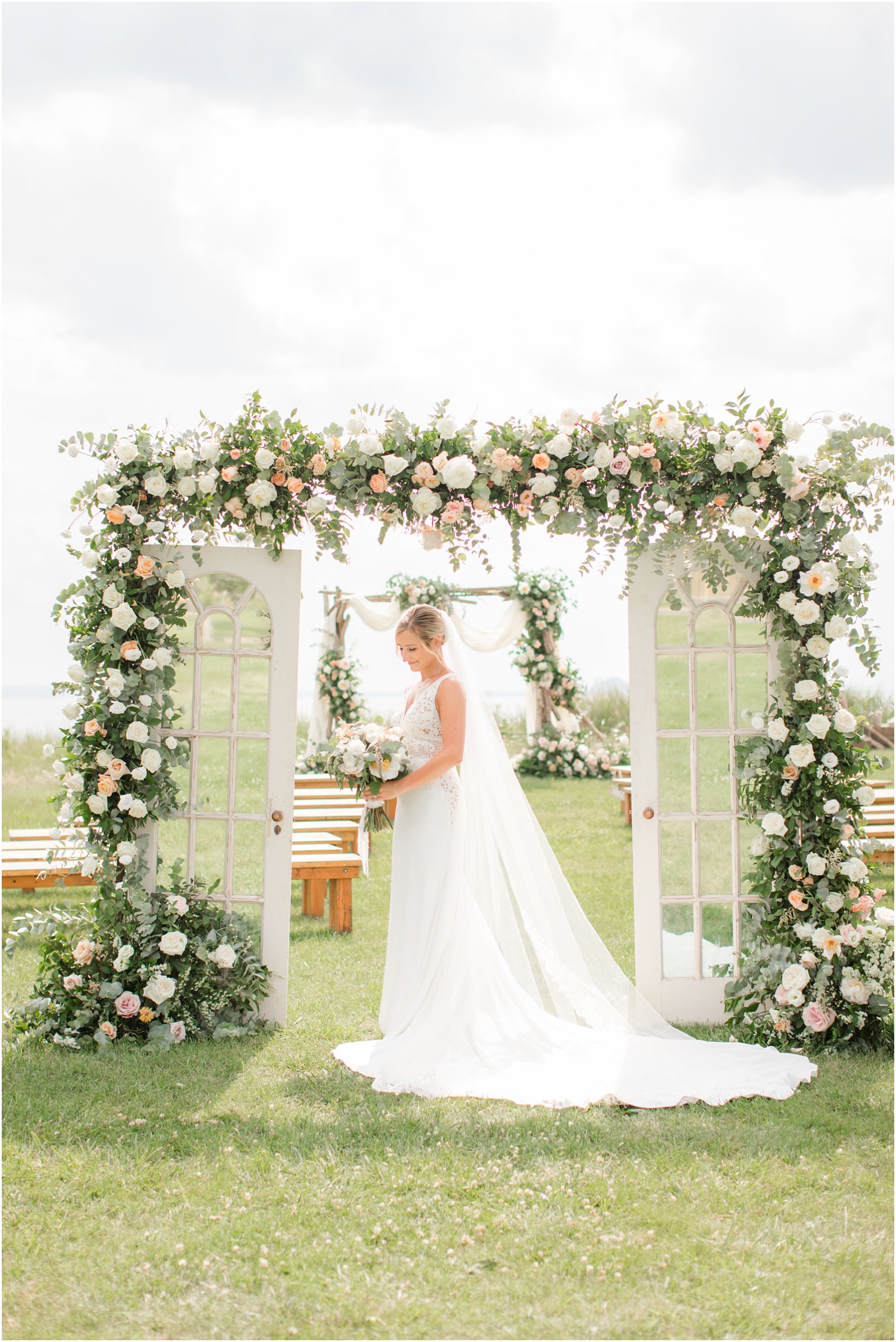 bridal portrait under floral arch at Sandy Hook Chapel with Idalia Photography
