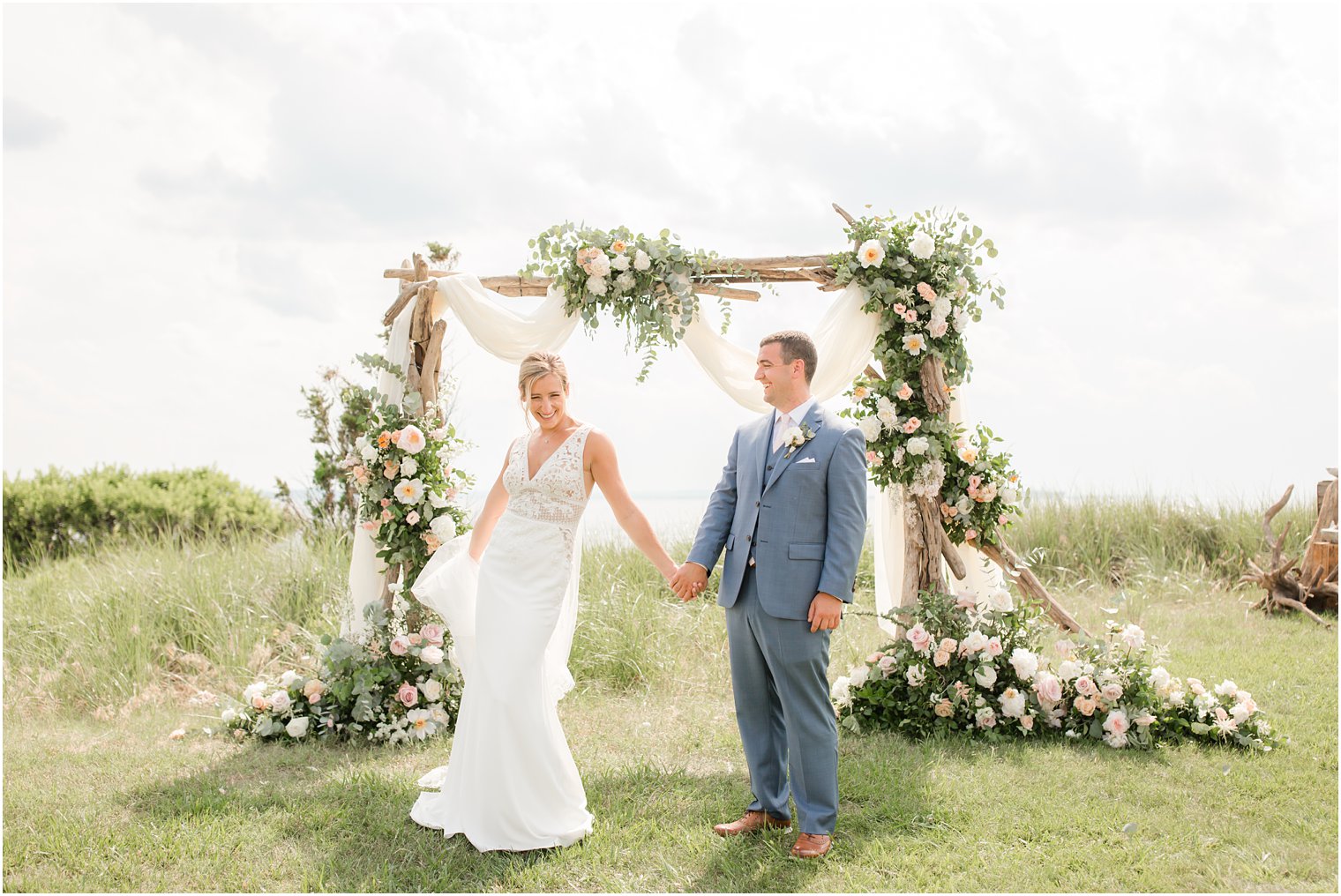 bride and groom photographed at Sandy Hook Chapel ceremony site with Idalia Photography