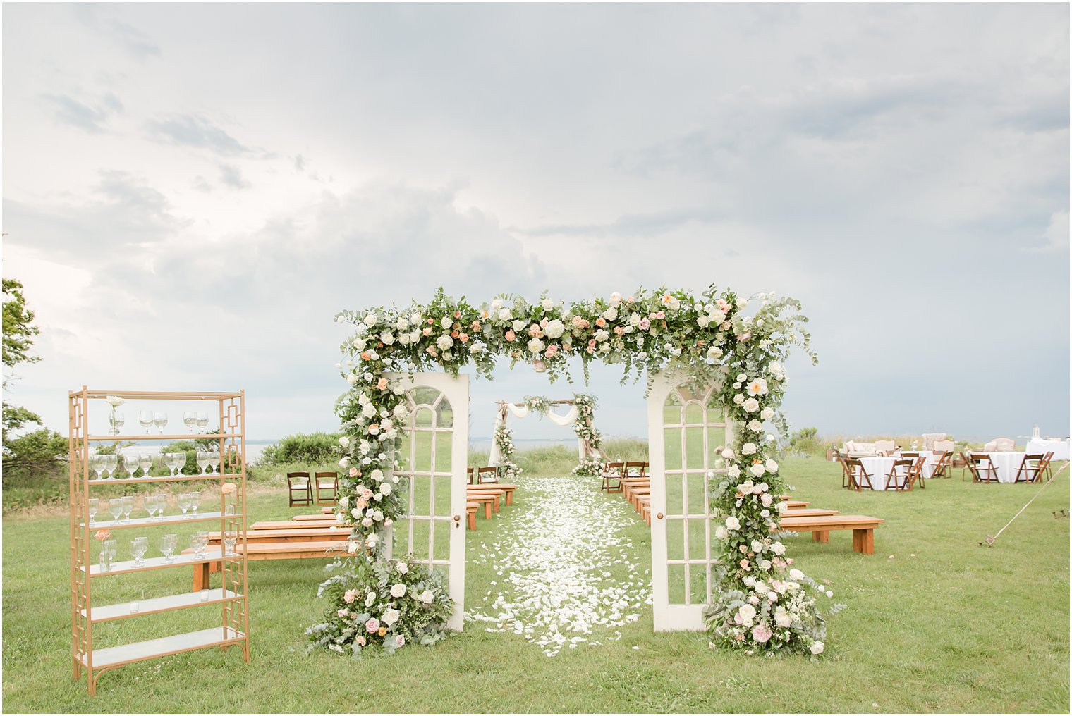 Sandy Hook Chapel wedding ceremony details with floral arch by Idalia Photography