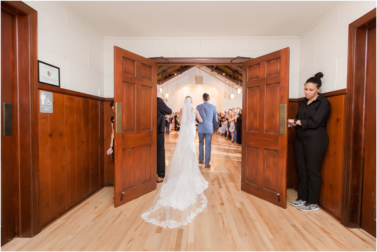 bride walks down aisle with Man of Honor photographed by Idalia Photography