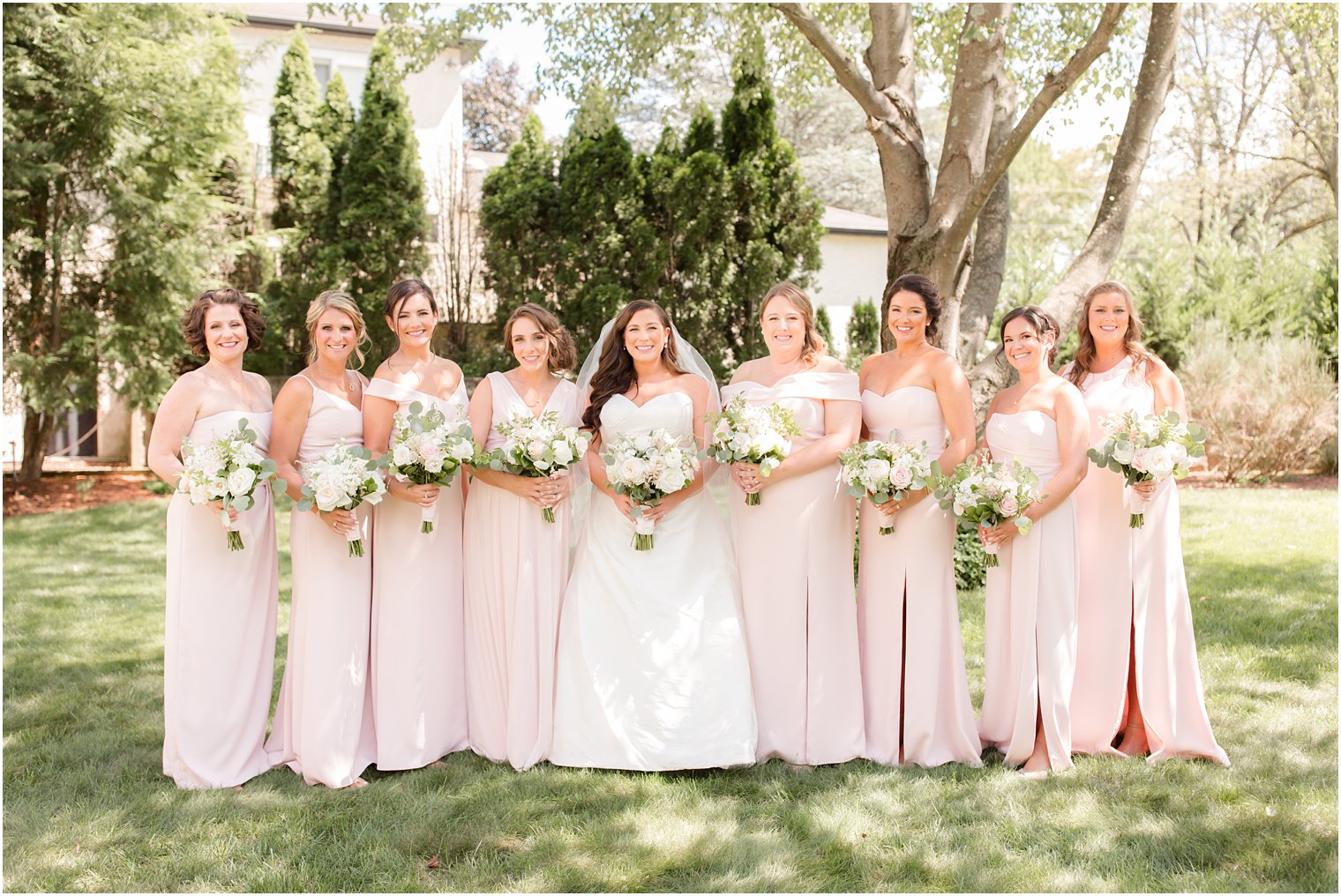 Bridesmaids wearing pink mismatched dresses