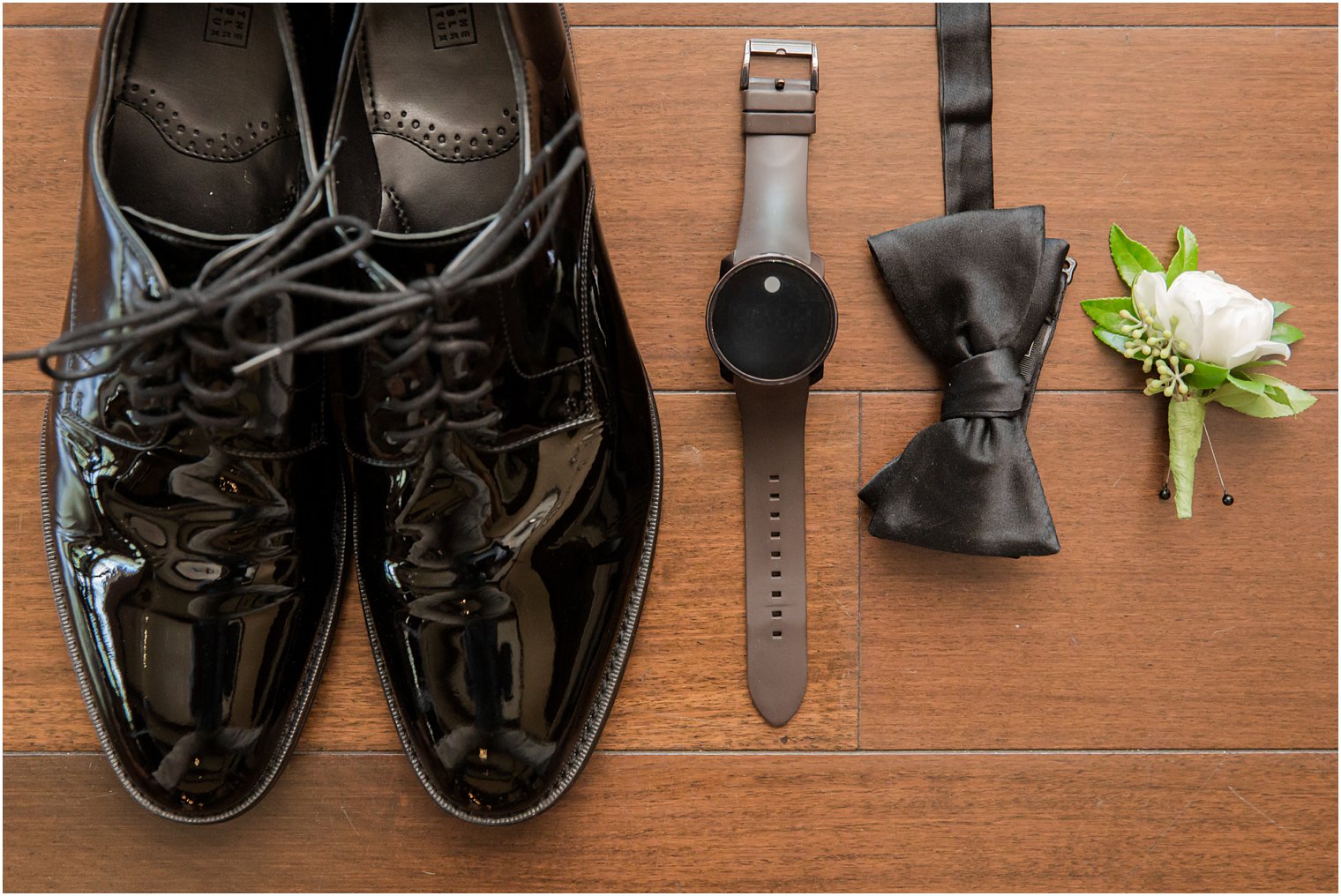 Groom's shoes, watch, bow tie, and boutonniere