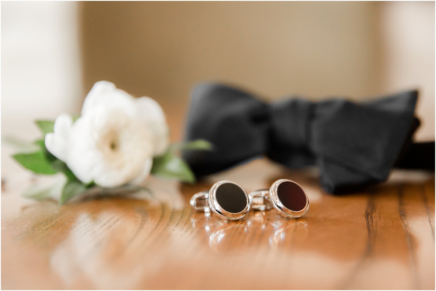 Groom's cufflinks with boutonniere and bow tie