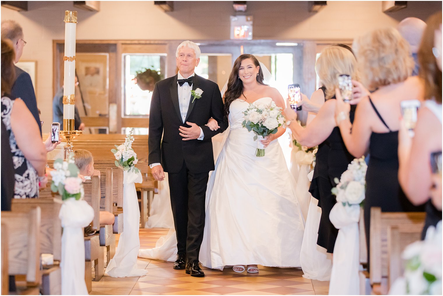 Bride walking down the aisle with her father at St. Luke's Church in Ho-Ho-Kus