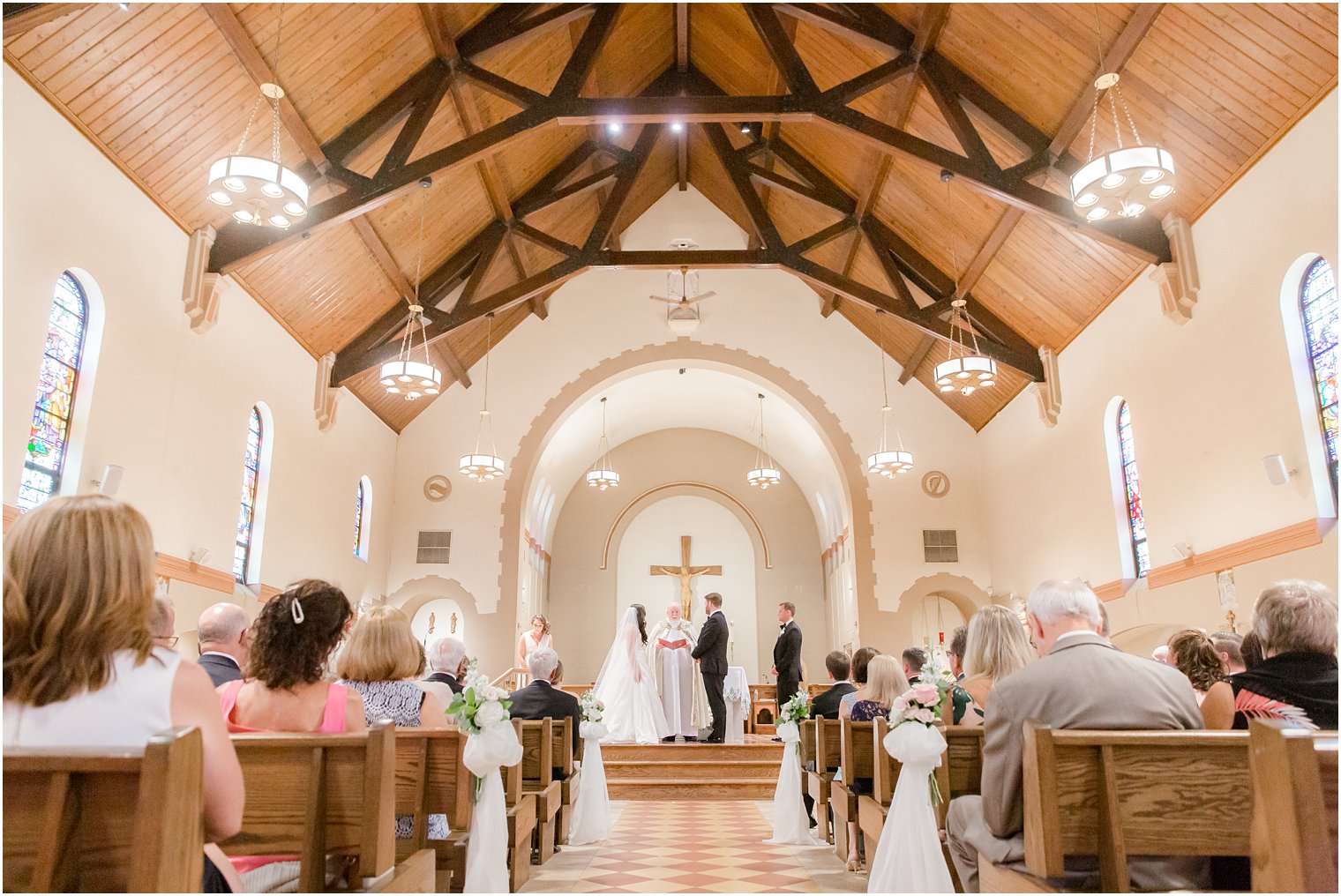 Bride and groom exchanging vows at the altar in St. Luke's Church in Ho-Ho-Kus