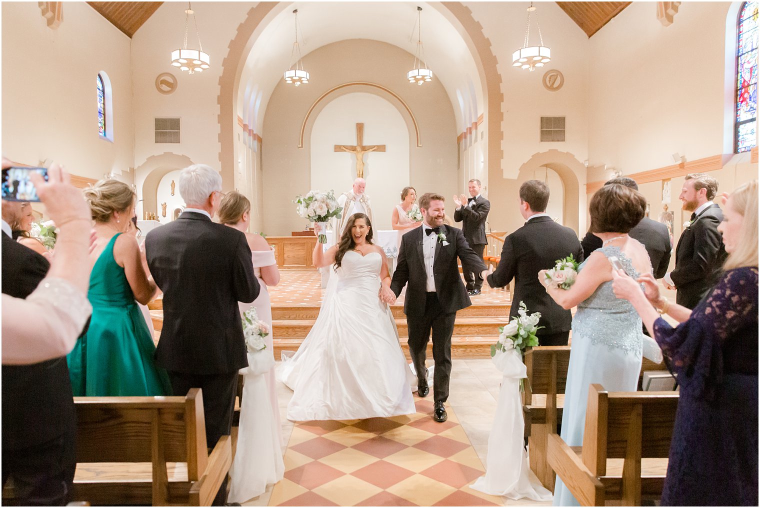 Bride and groom walking down the aisle in St. Luke's Church in Ho-Ho-Kus