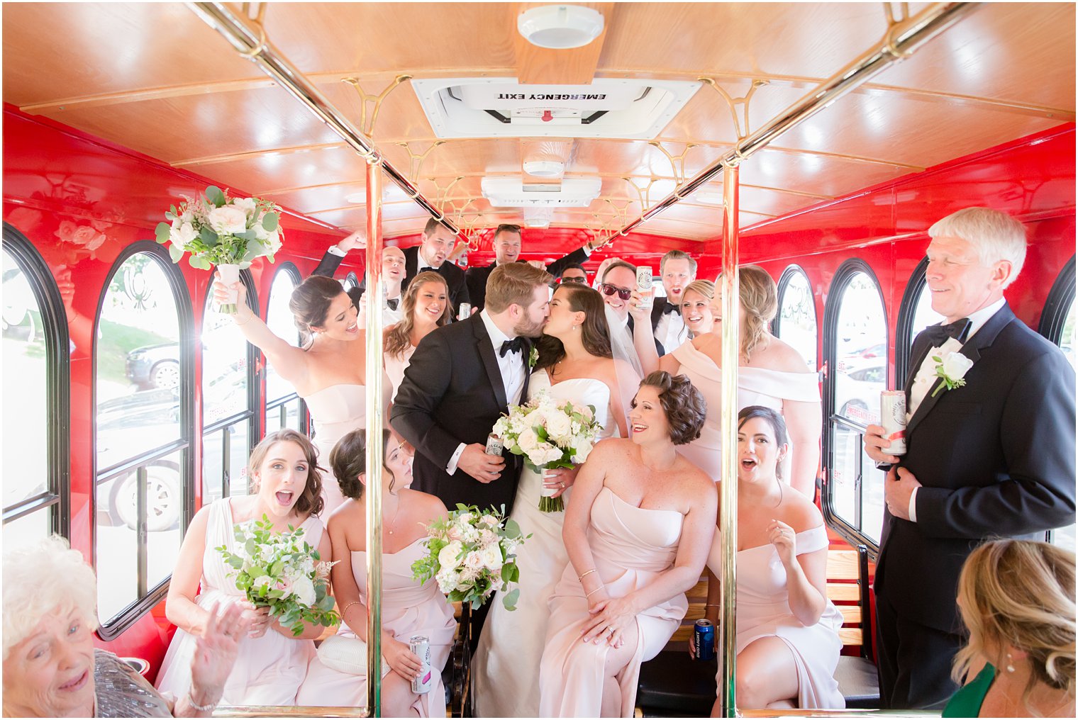 Bride and groom kissing in trolley after wedding ceremony in St. Luke's Church in Ho-Ho-Kus