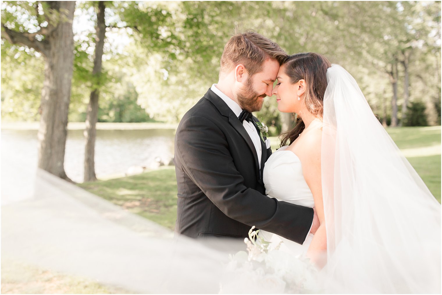 Bride and groom portraits by the lake at Indian Trail Club 
