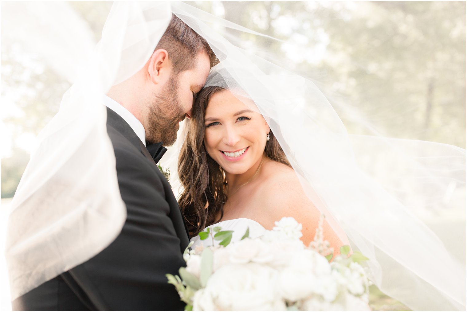 Bride and groom during portraits at a black tie wedding at Indian Trail Club