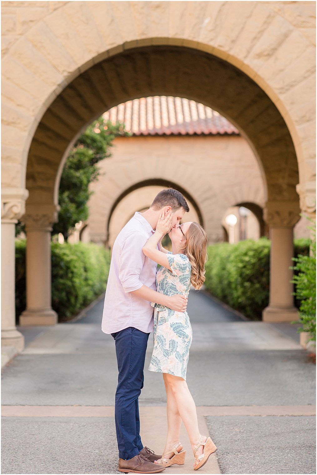 Couple kissing under an arch at Stanford University