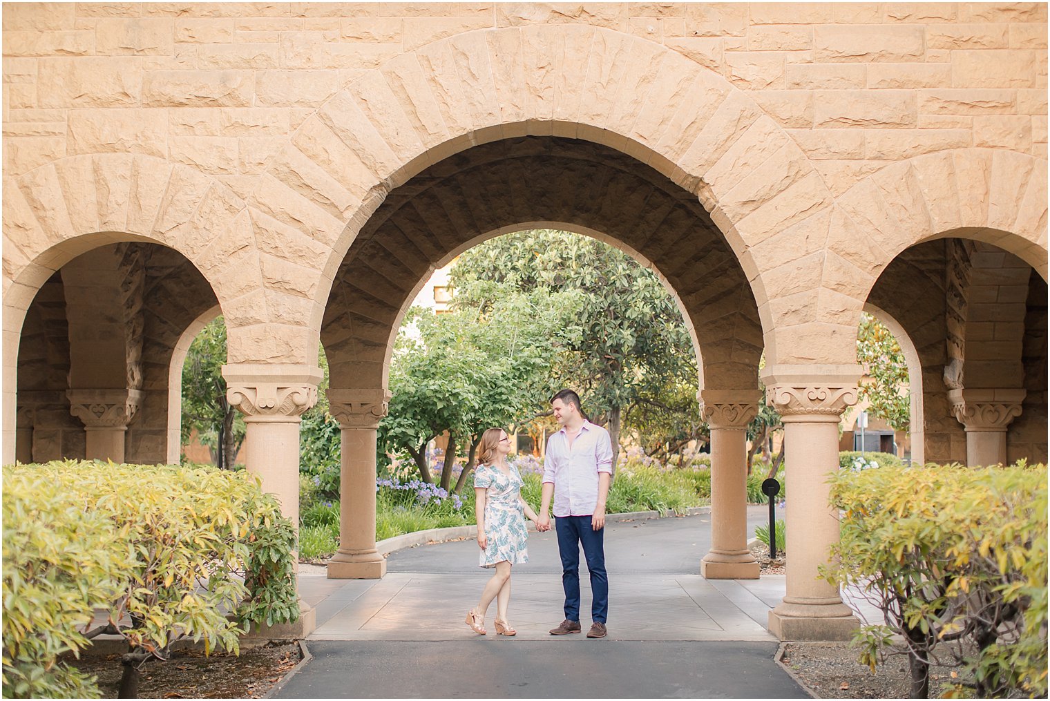 Engagement photos under an arch on Stanford campus