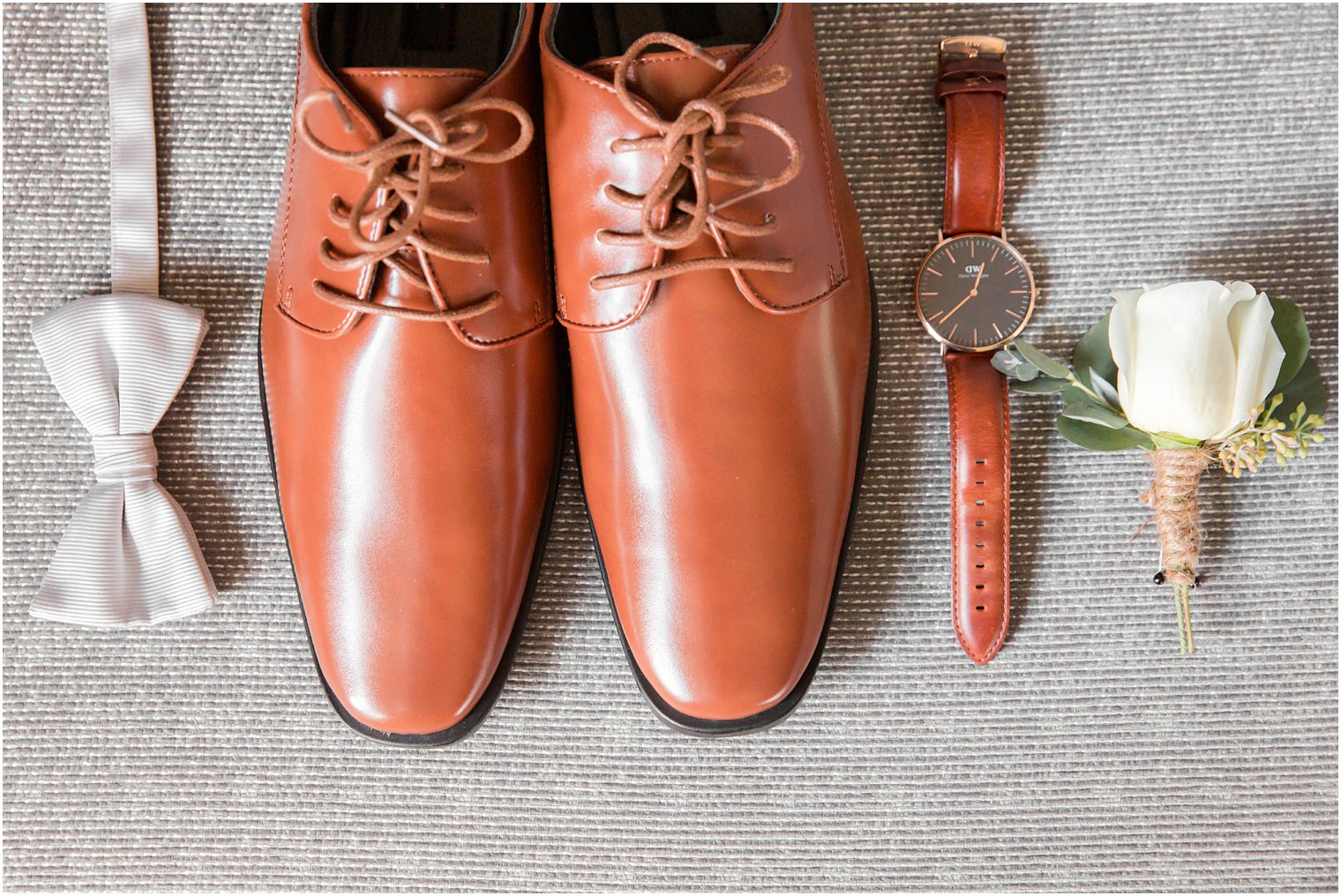 Groom's shoes, bow tie, watch, and boutonniere