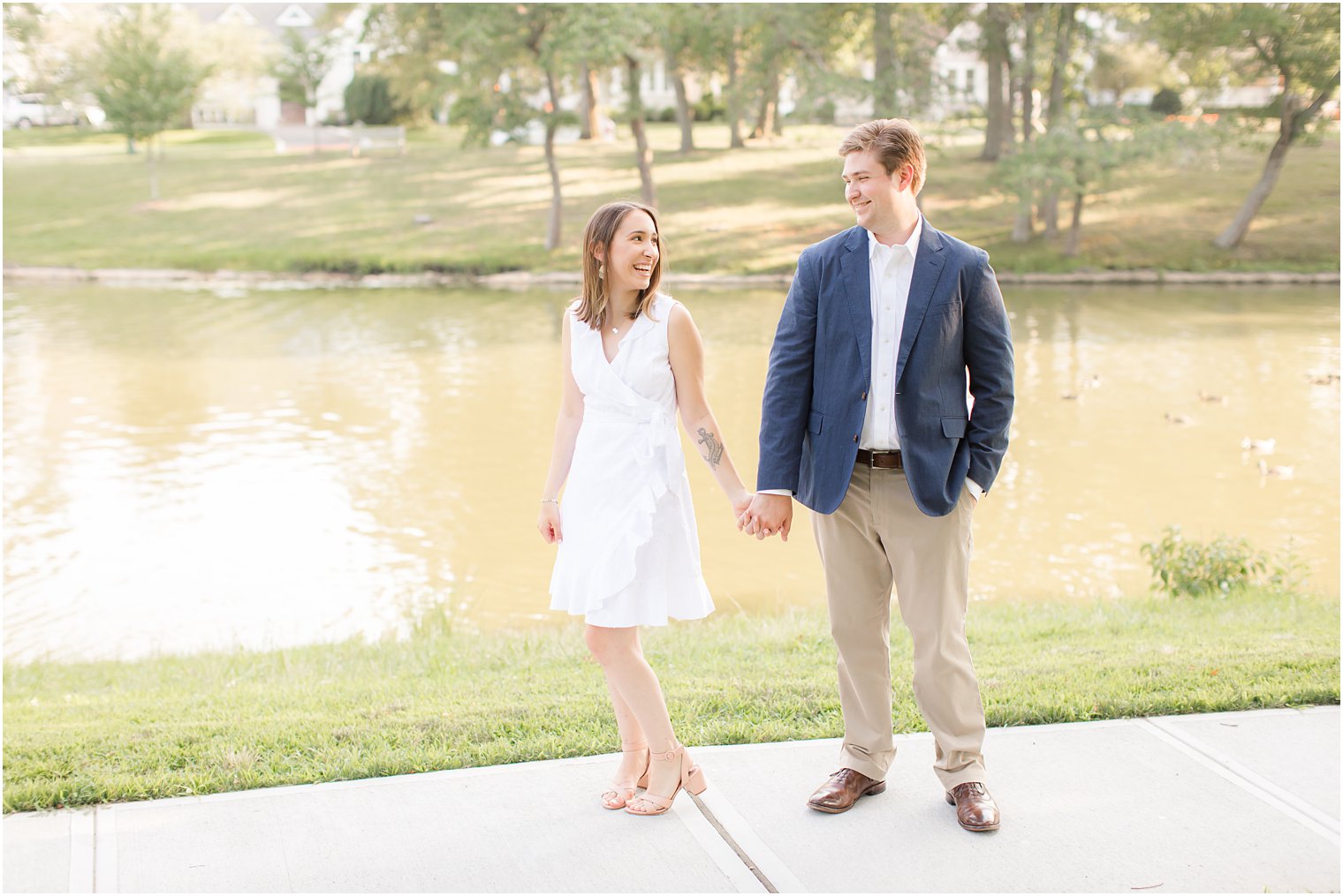 Bride and groom posing for engagement photos in Spring Lake, NJ