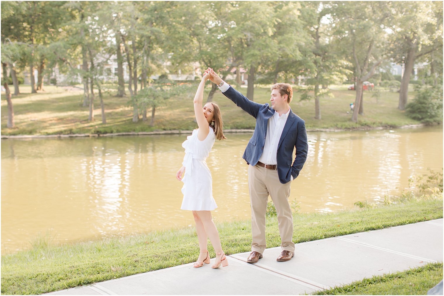 Groom twirling his bride in Summer Engagement in Spring Lake, NJ