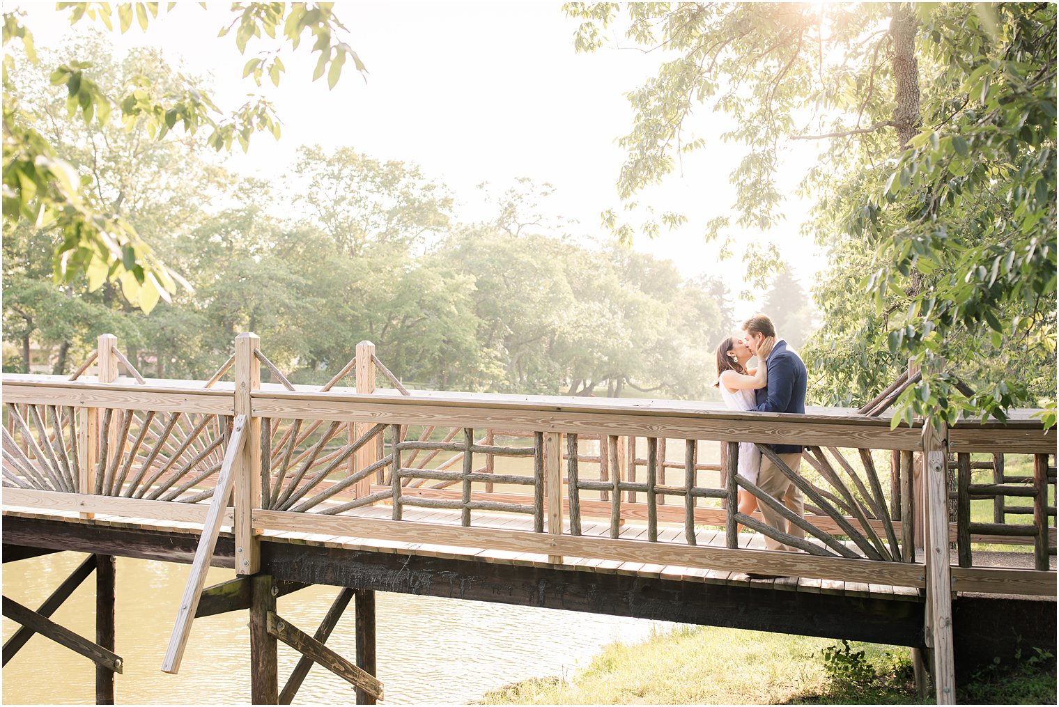 Bride and groom kissing on bridge in Divine Park in Spring Lake NJ 