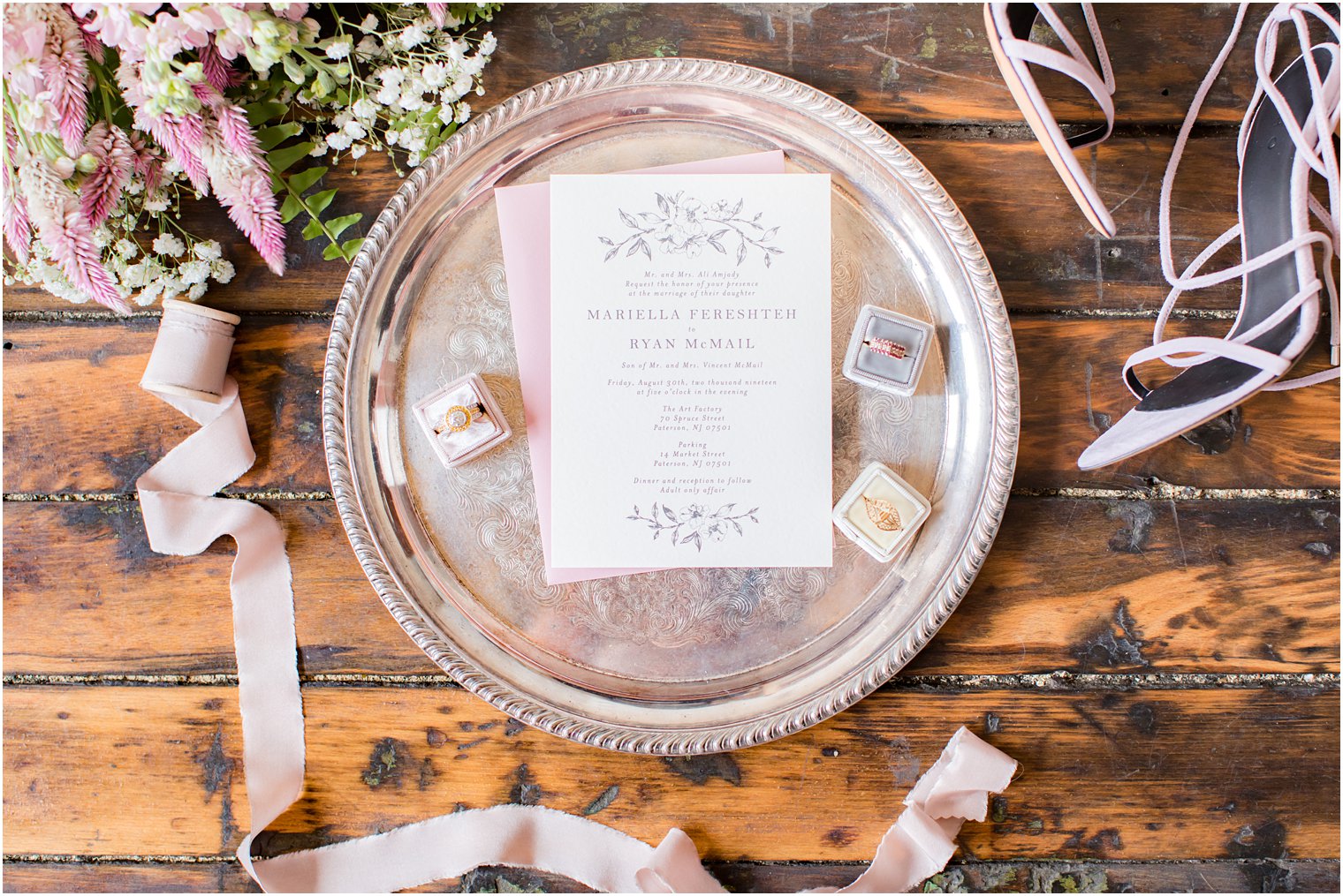 Wedding invitation with mauve envelope on a silver tray