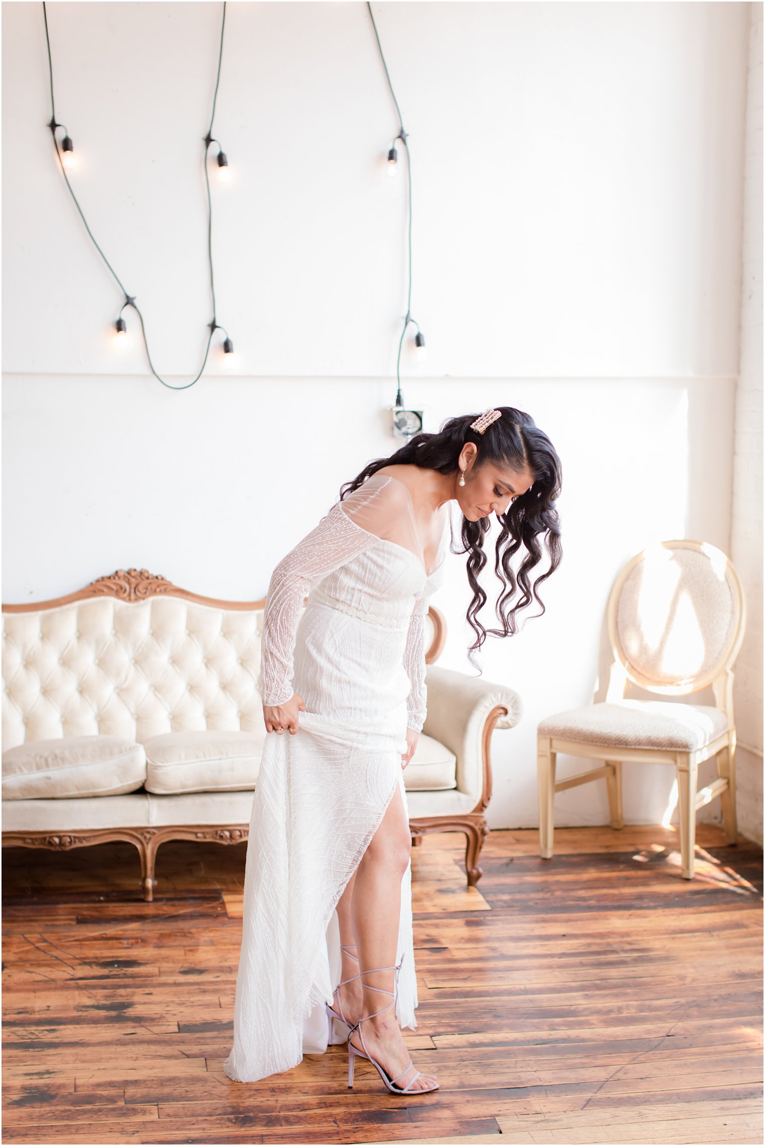 Bride wearing white BHLDN dress and purple heels