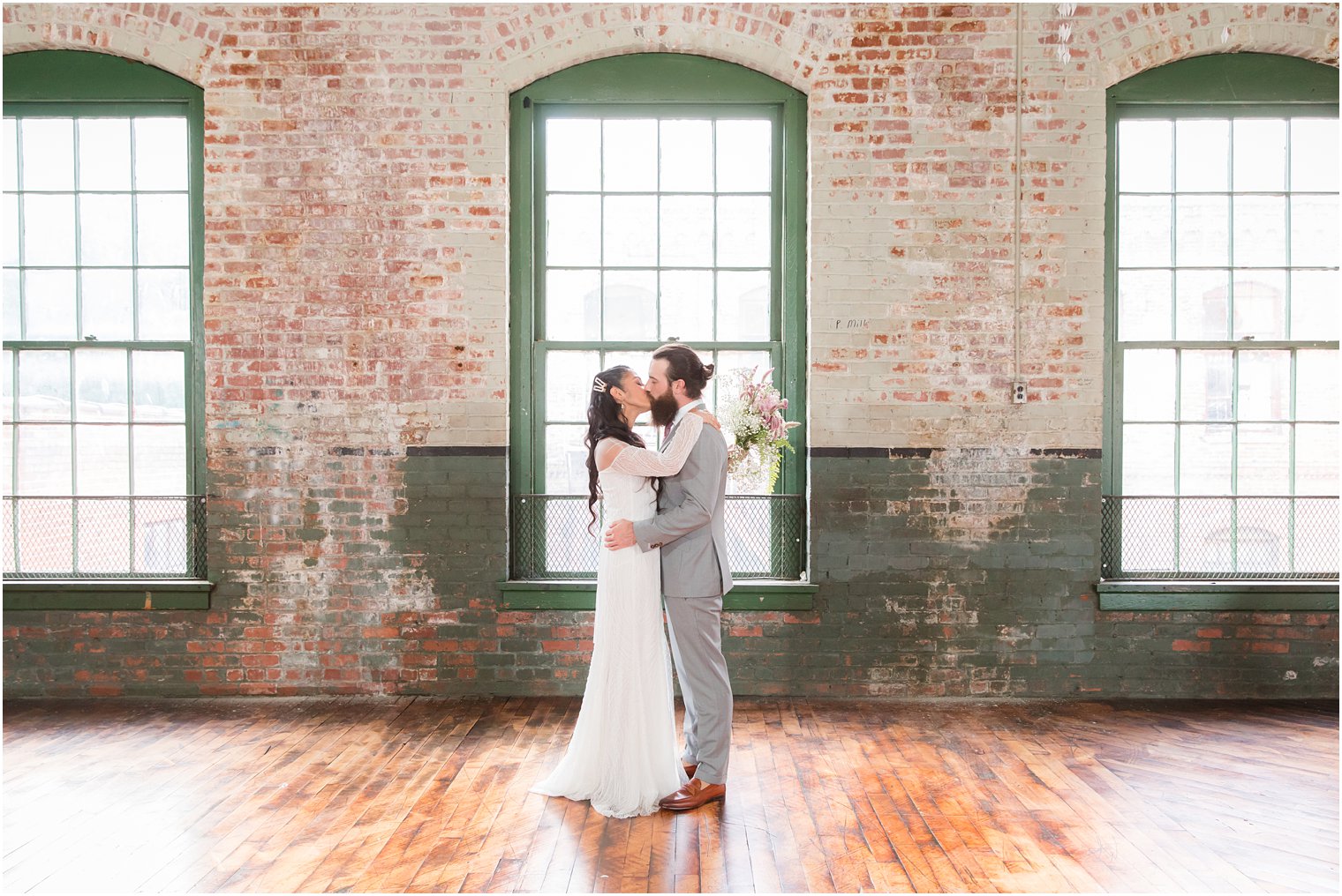 Bride and groom kissing during portrait session 
