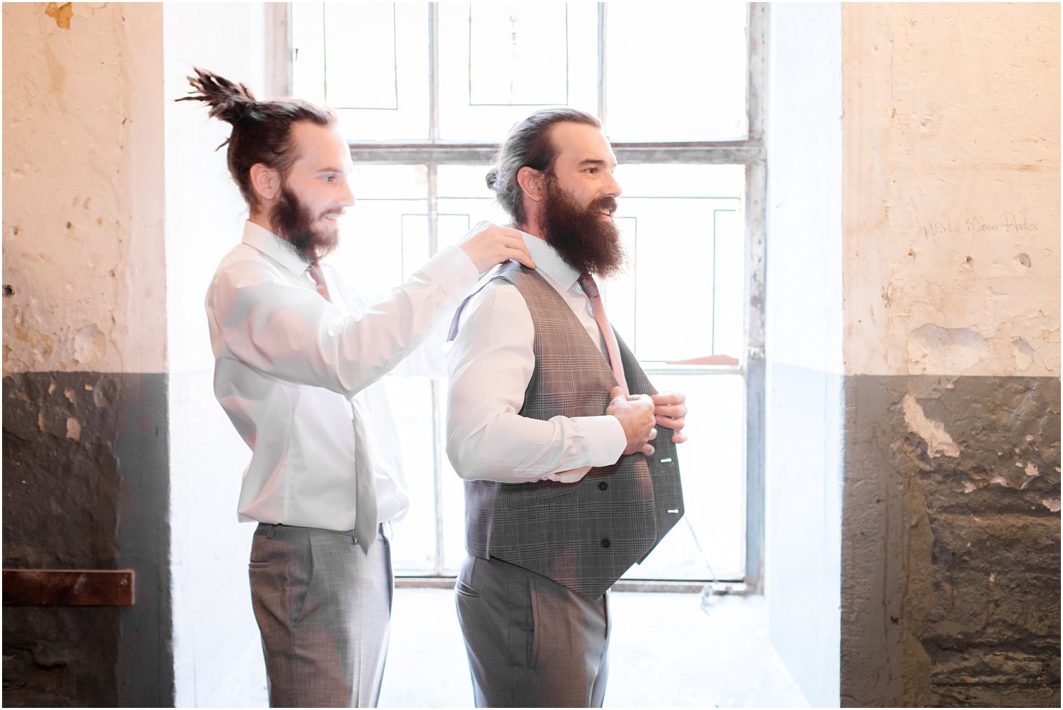 groom and best man getting dressed