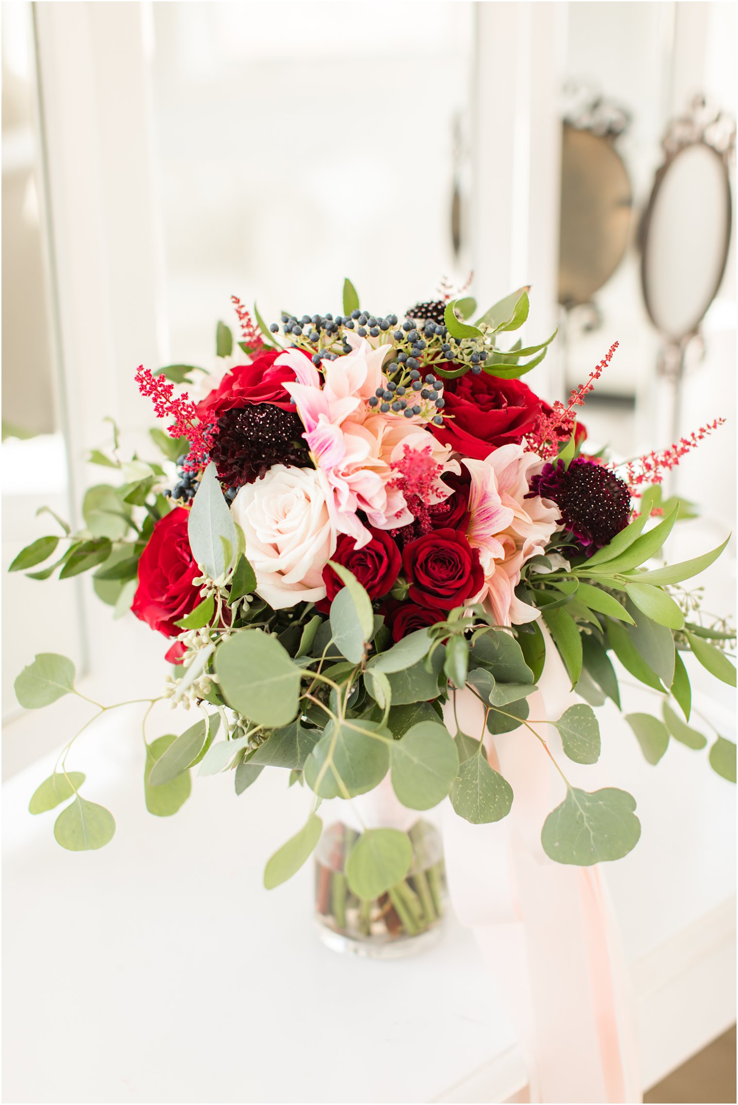 fall bridal bouquet with red and pink by A Touch of Elegance Events