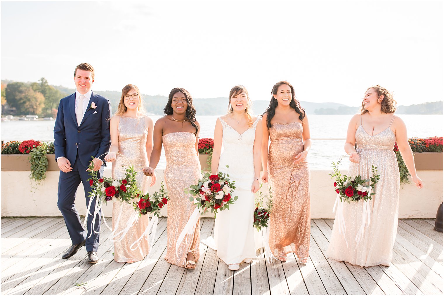 bridesmaids and bridesman with copper floral hoops and red roses for Lake Mohawk wedding day