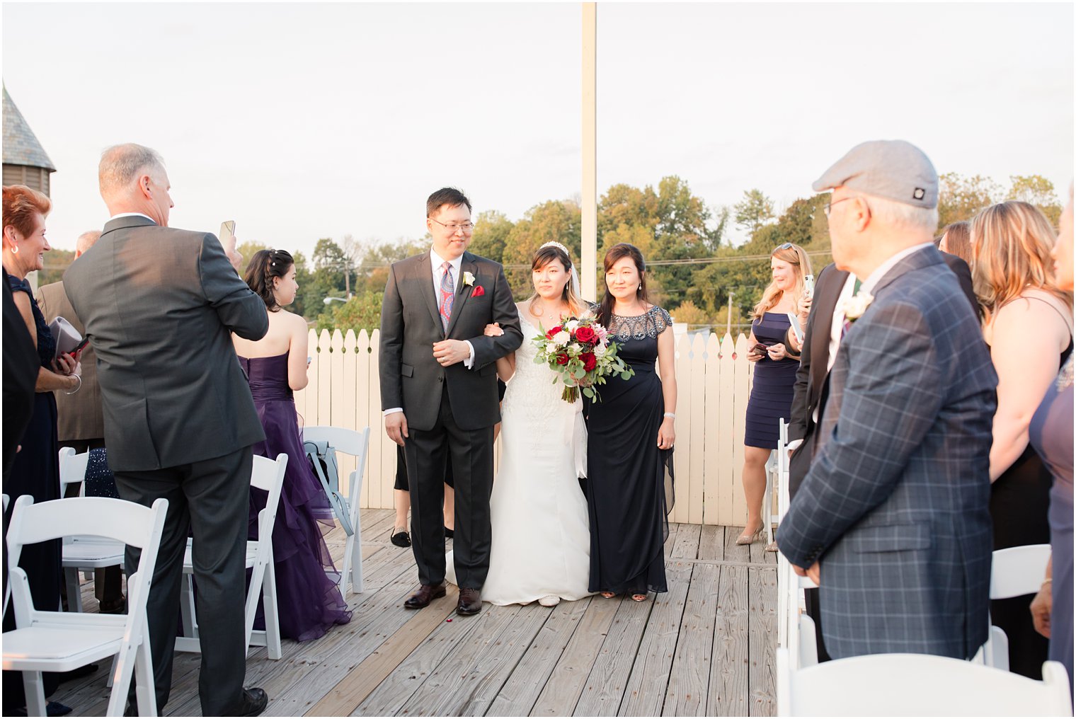 bride walks down aisle at Lake Mohawk with Idalia Photography