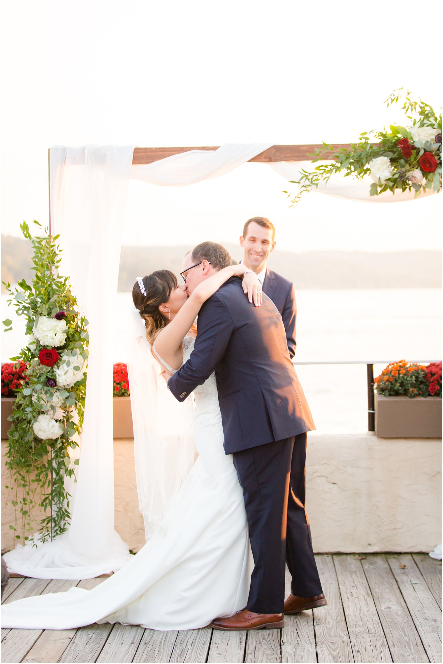 first kiss as husband and wife at Lake Mohawk by Idalia Photography