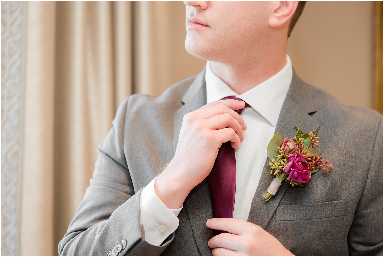 groom adjusts tie before Park Chateau wedding day