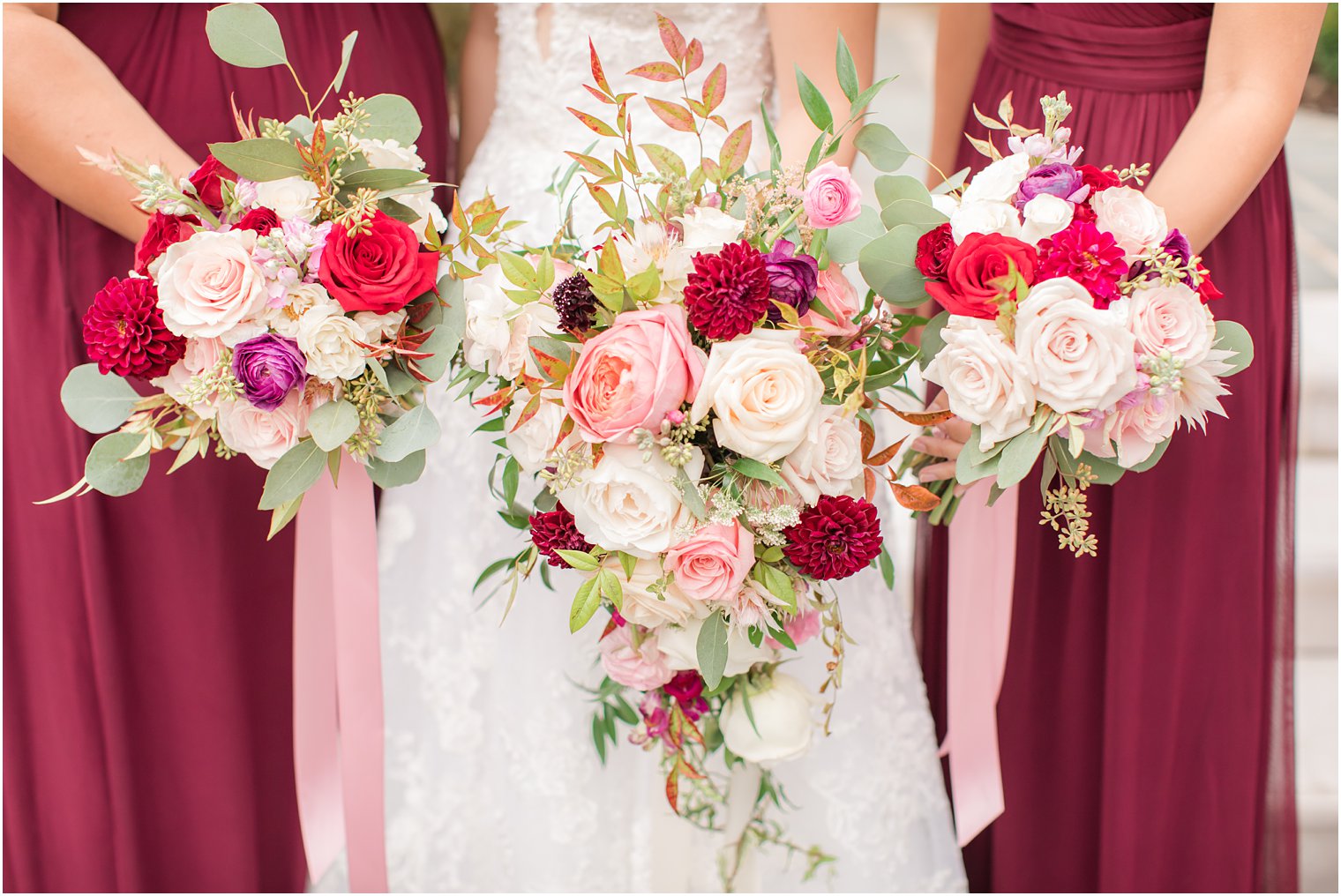 pink, ivory, and red floral bouquets by Pink Dahlia Vintage