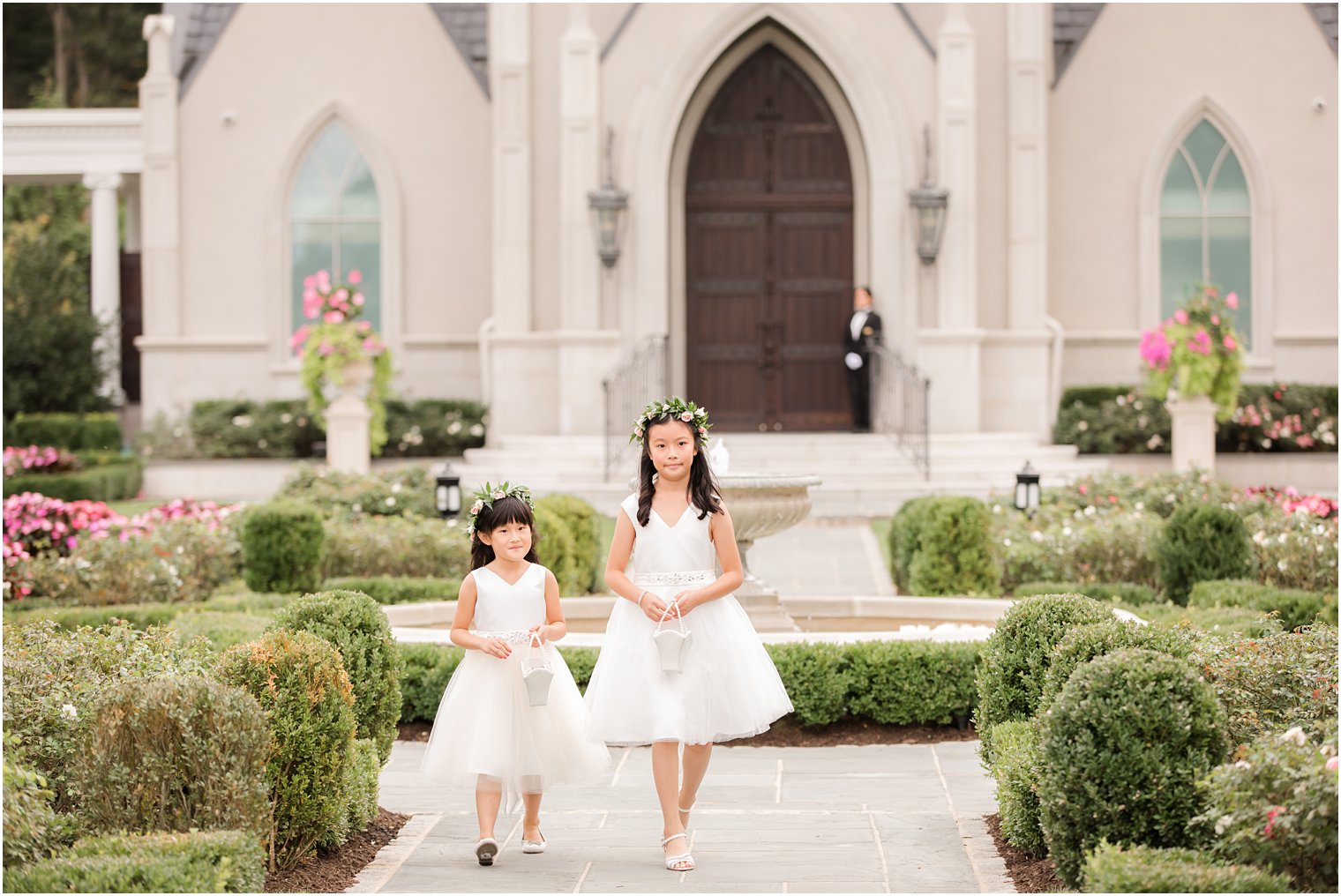 flower girls walk down aisle by Idalia Photography