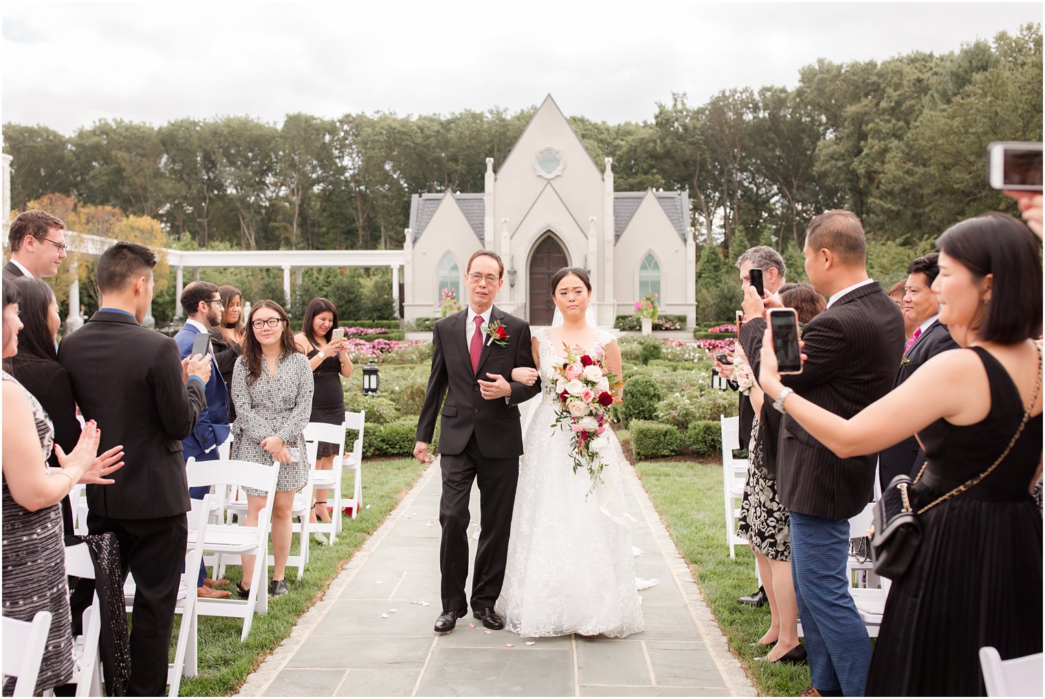 bride walks down the aisle at Park Chateau Estate with Idalia Photography