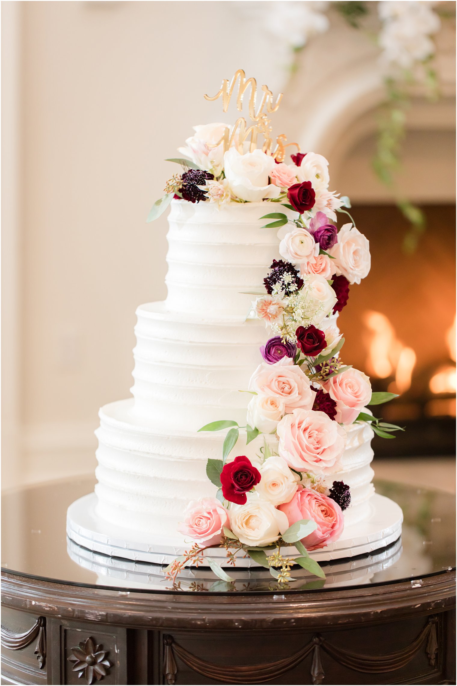 tiered wedding cake with floral details photographed by Idalia Photography