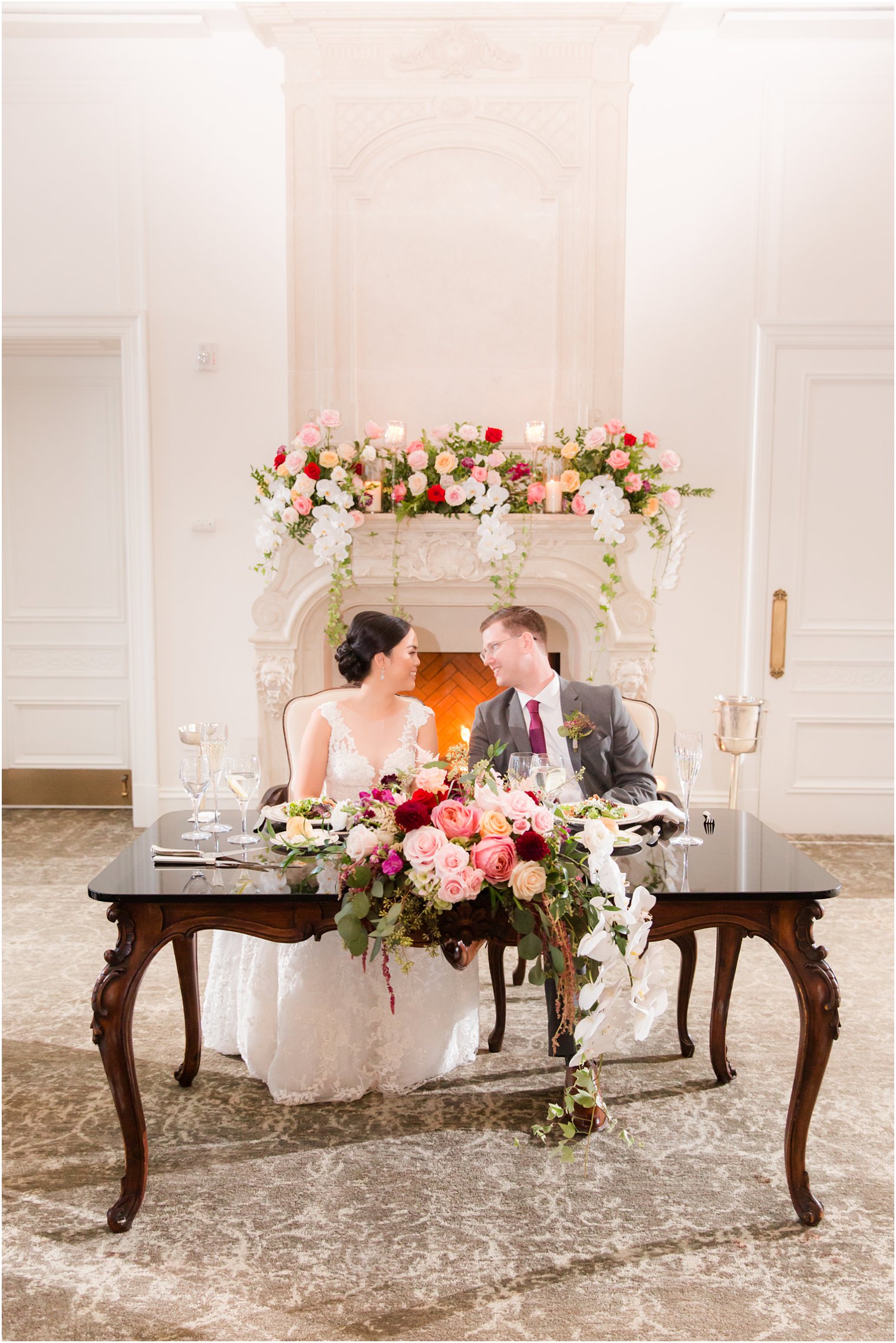 bride and groom at sweetheart table during Park Chateau Estate wedding reception photographed by Idalia Photography
