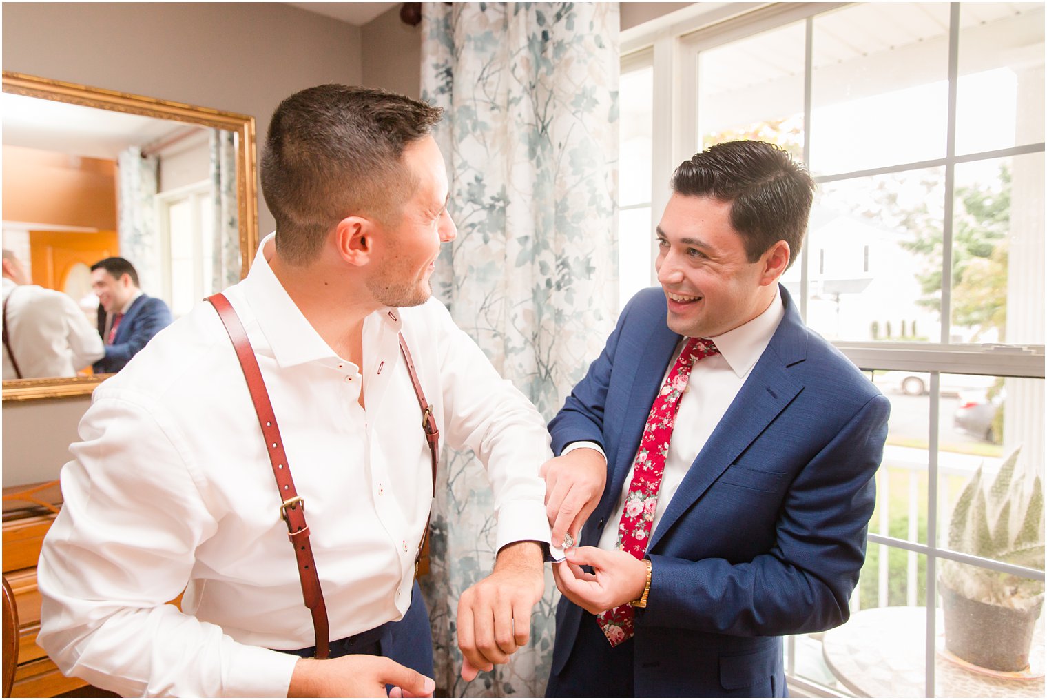 Groom getting ready with best man on wedding day 