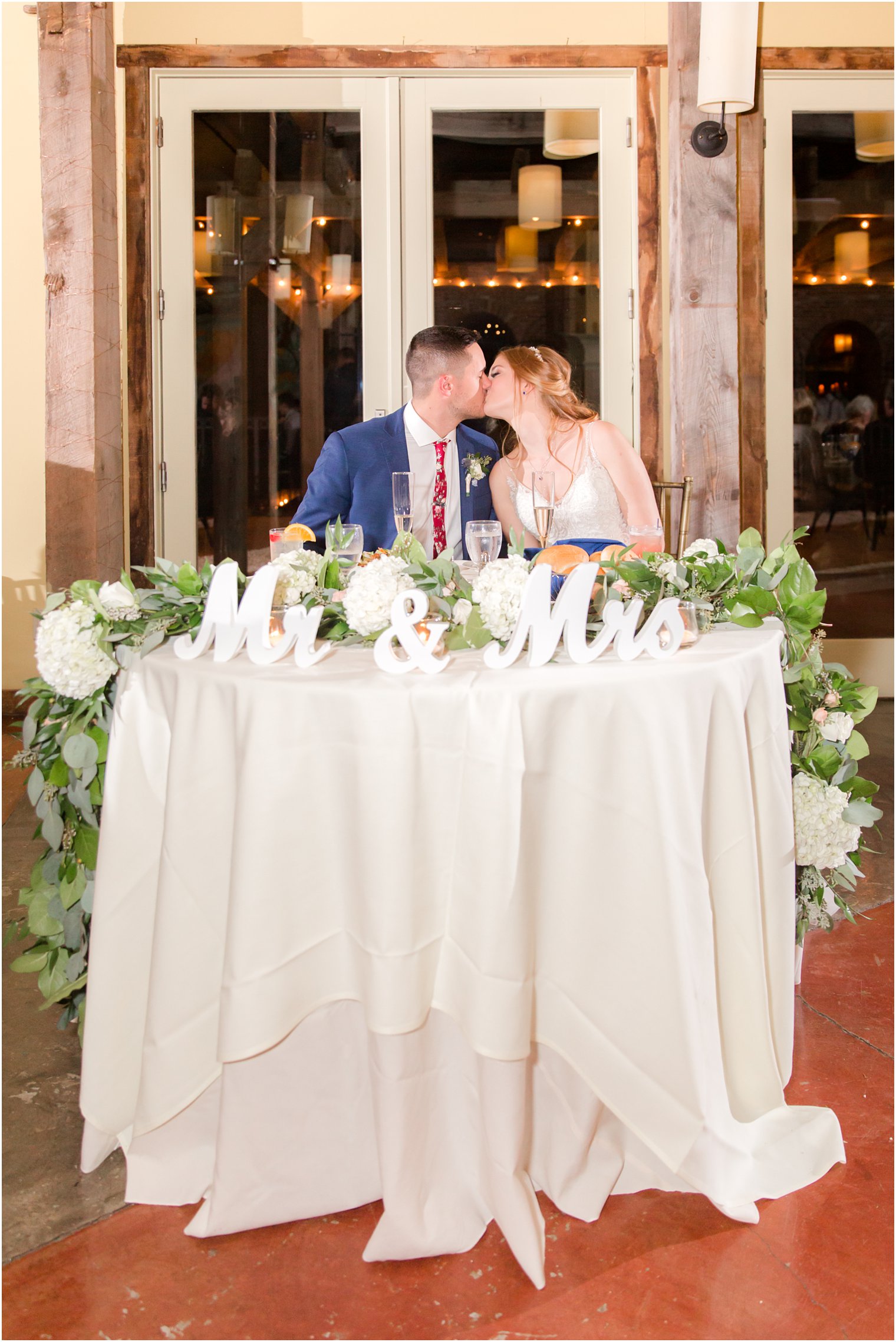 Newlyweds at sweetheart table at Laurita Winery in New Egypt NJ | NJ vineyard wedding venue