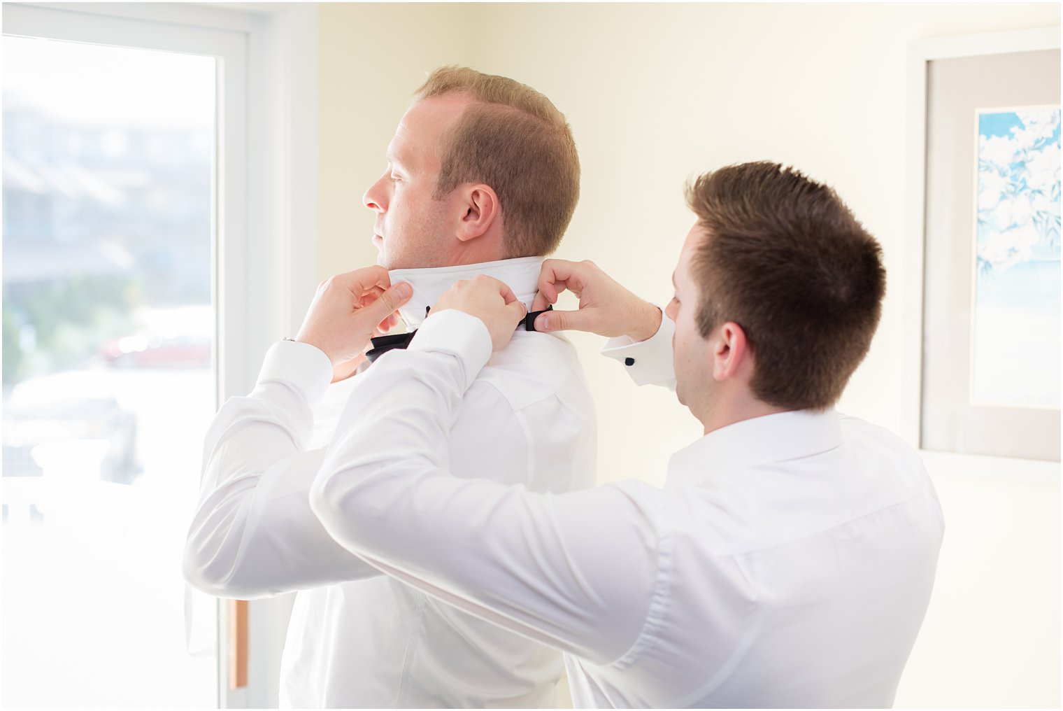 Groom getting ready with best man at Drifting Sands Motel