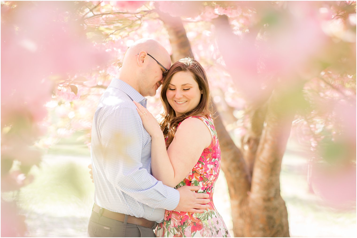 Romantic engagement photos in the cherry blossoms at Branch Brook Park