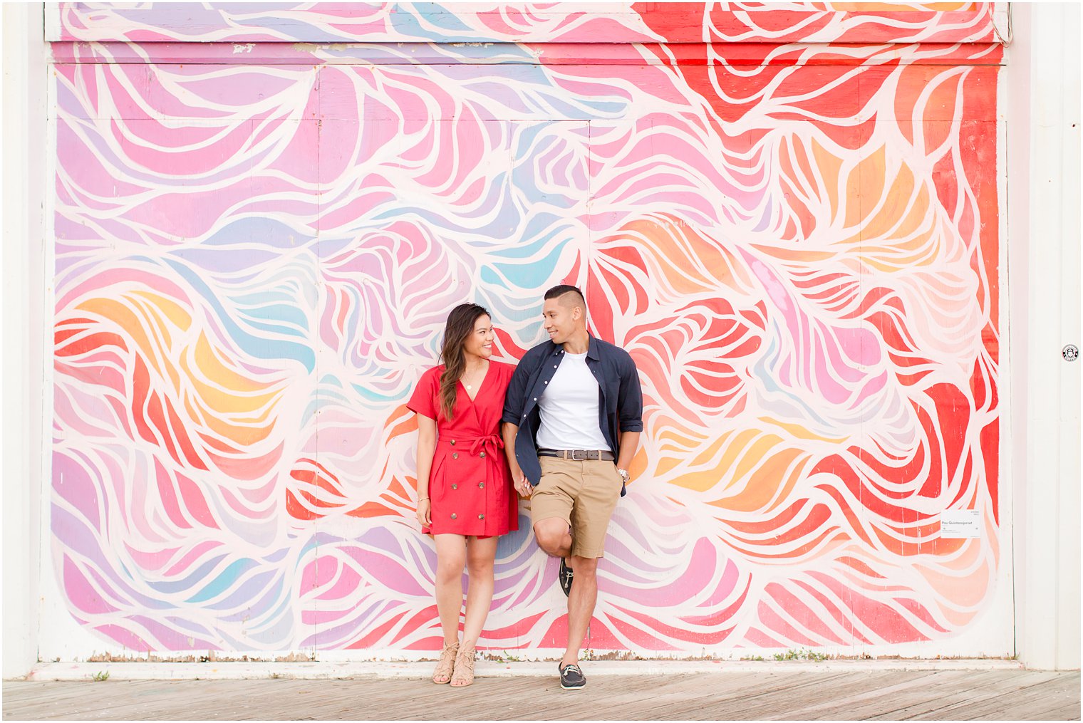 couple poses with colorful mural in Asbury Park with Idalia Photography