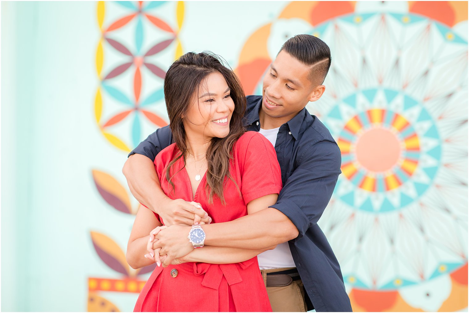 engagement portraits by colorful mural with Idalia Photography