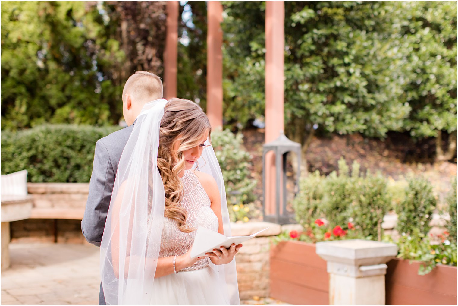 bride and groom read cards photographed by Idalia Photography