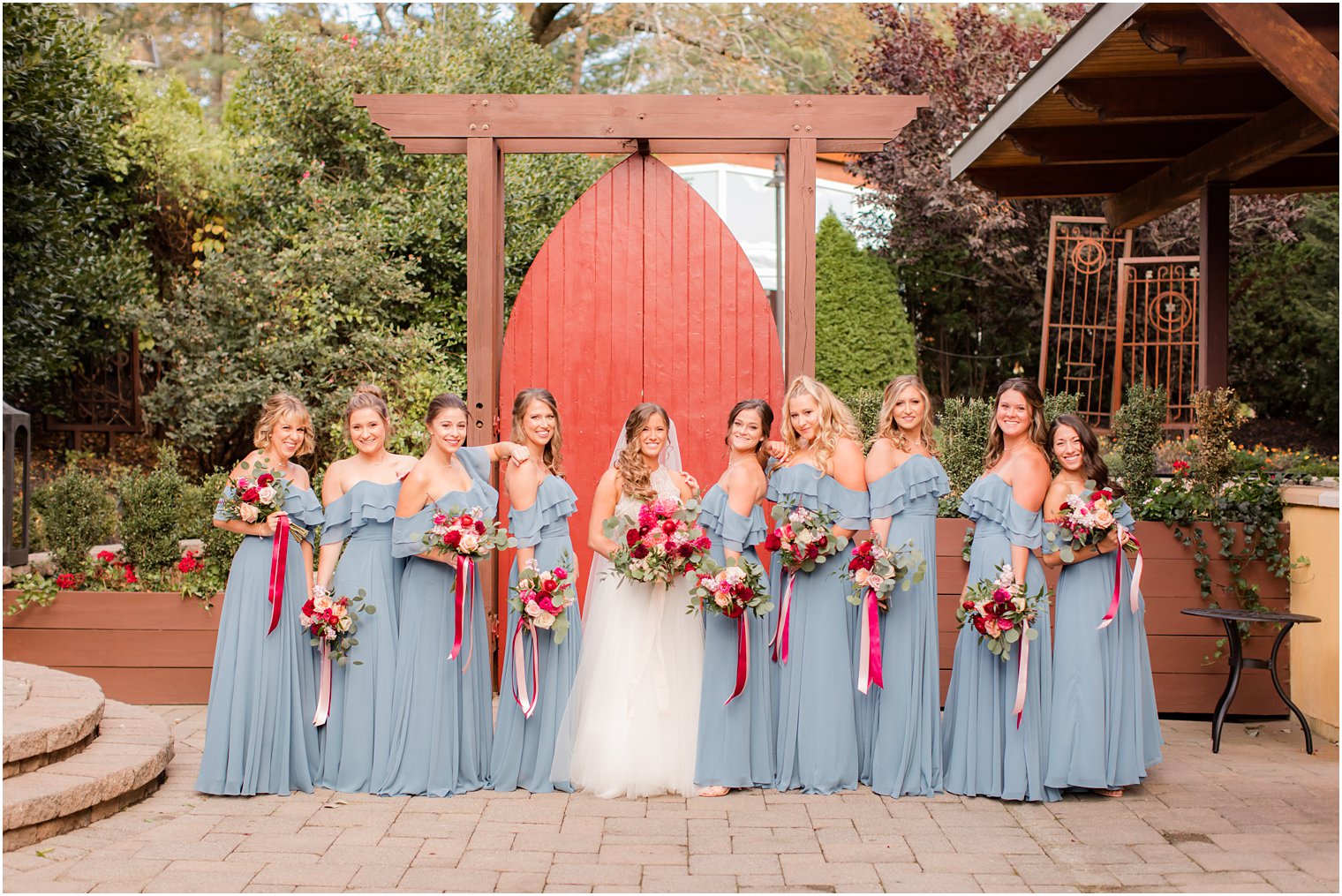bridesmaids in dusty blue gowns photographed by Idalia Photography
