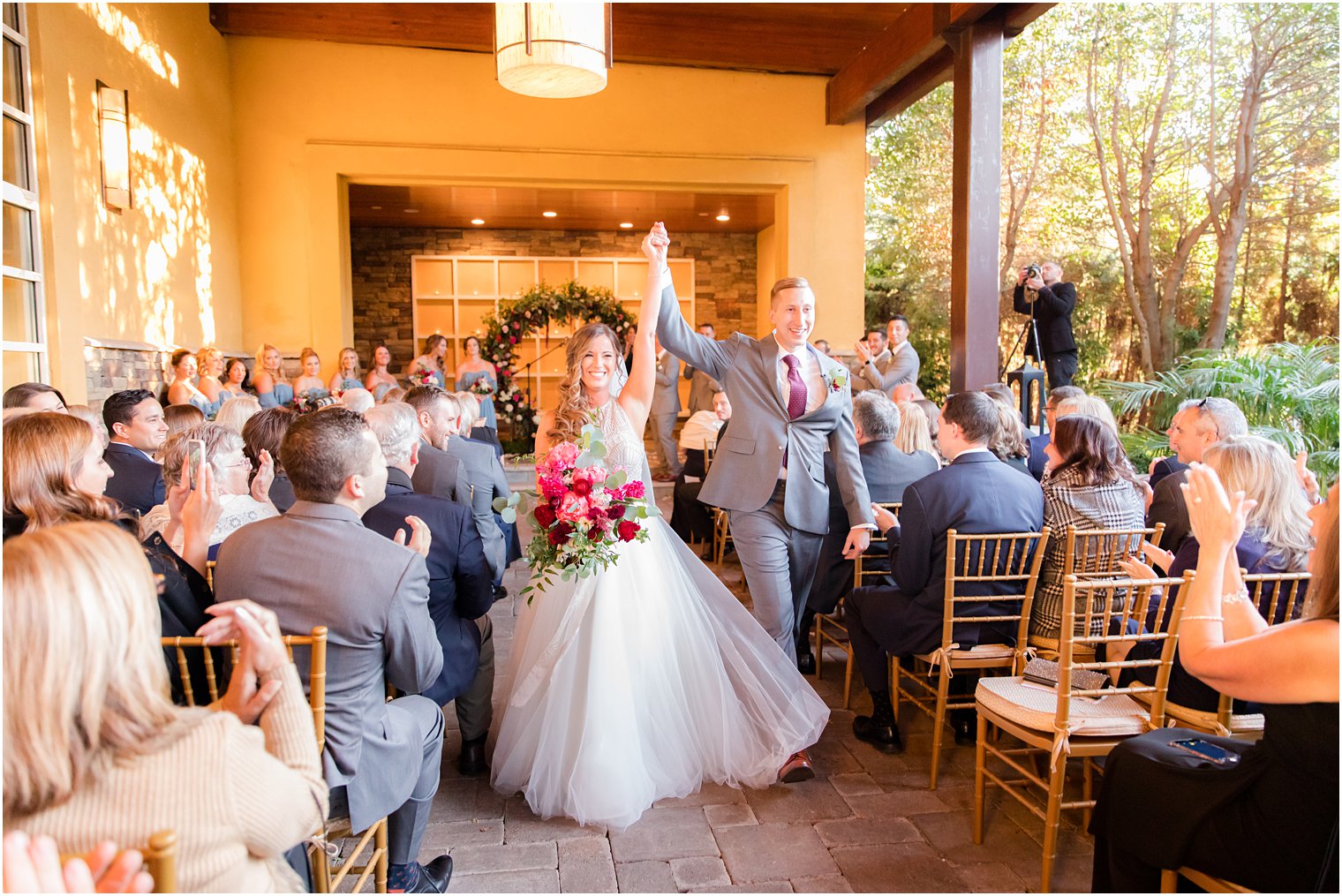 bride and groom recess down aisle at Stone House