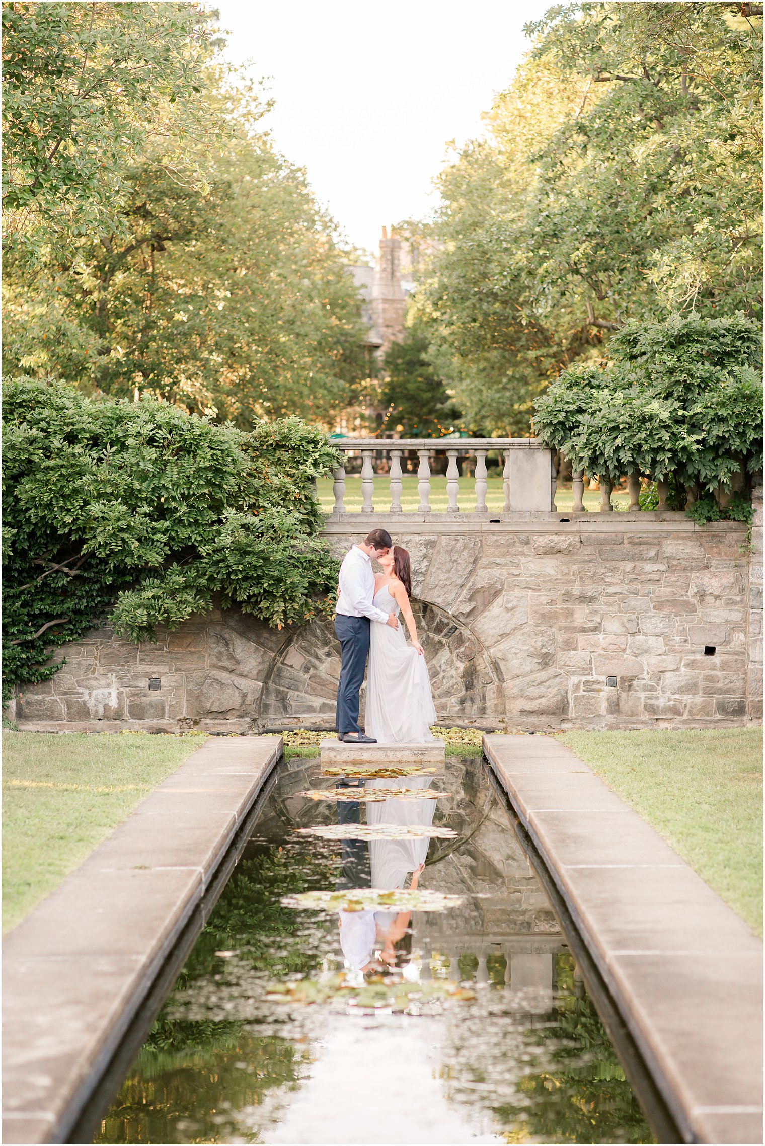 summer engagement at Skylands Manor along pond with Idalia Photography
