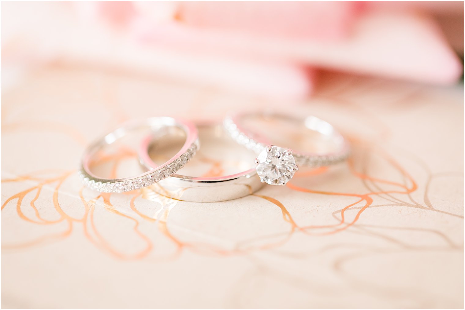 wedding rings on pink stationery photographed by Idalia Photography