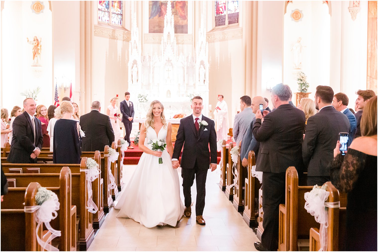 newlyweds leave church photographed by Idalia Photography
