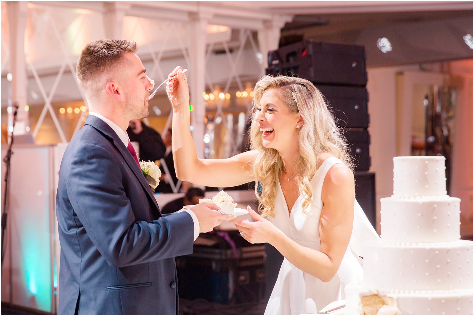 bride and groom cut cake photographed by Idalia Photography