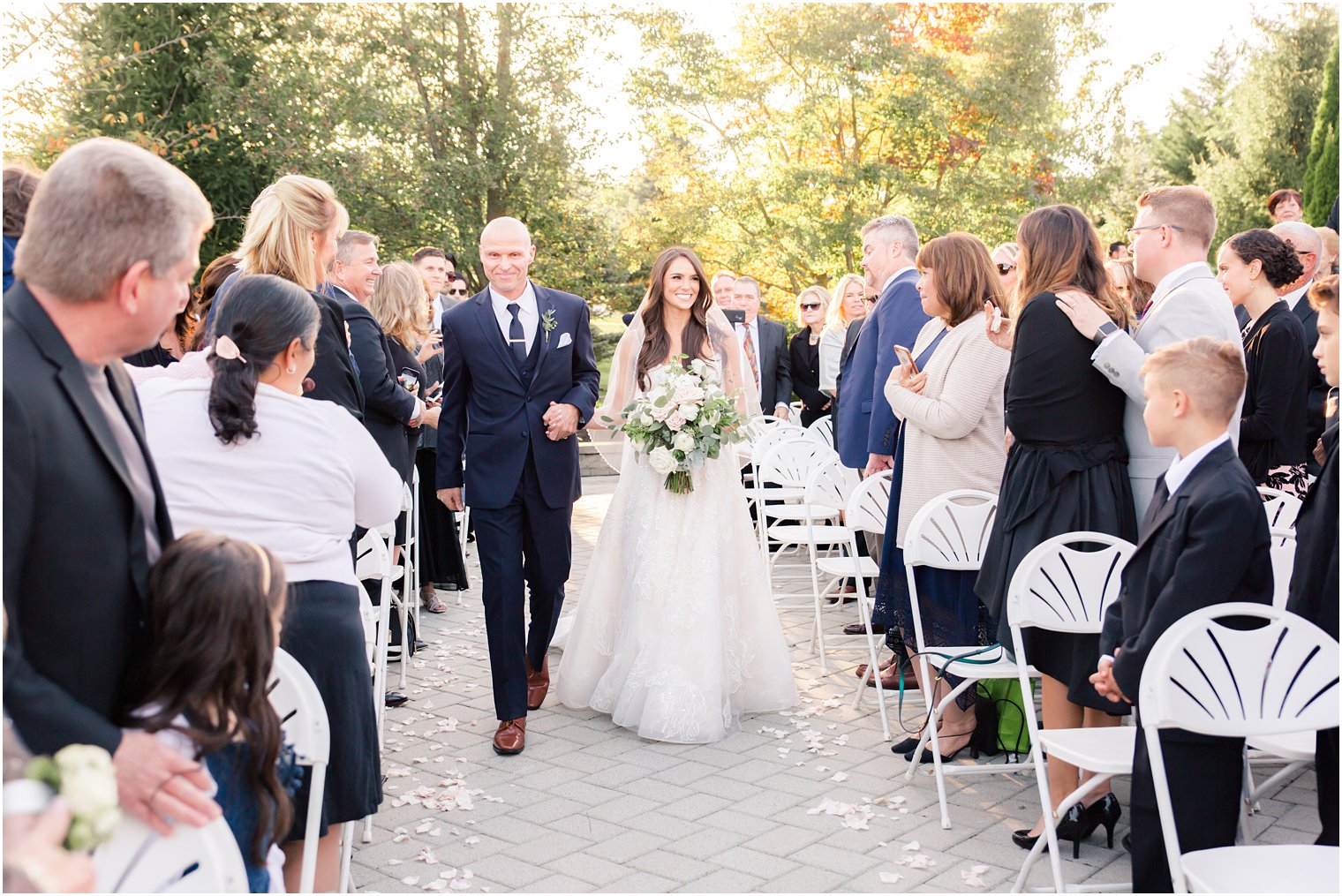 bride walks down the aisle at Windows on the Water at Frogbridge