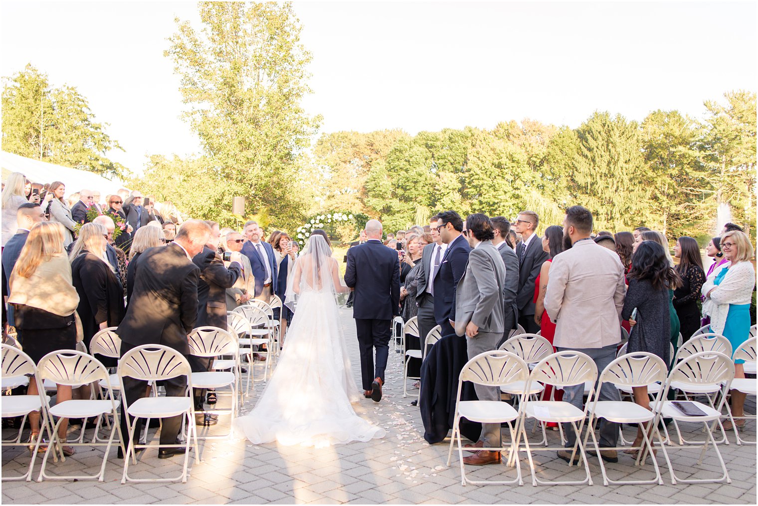 bride walks down the aisle at Windows on the Water at Frogbridge