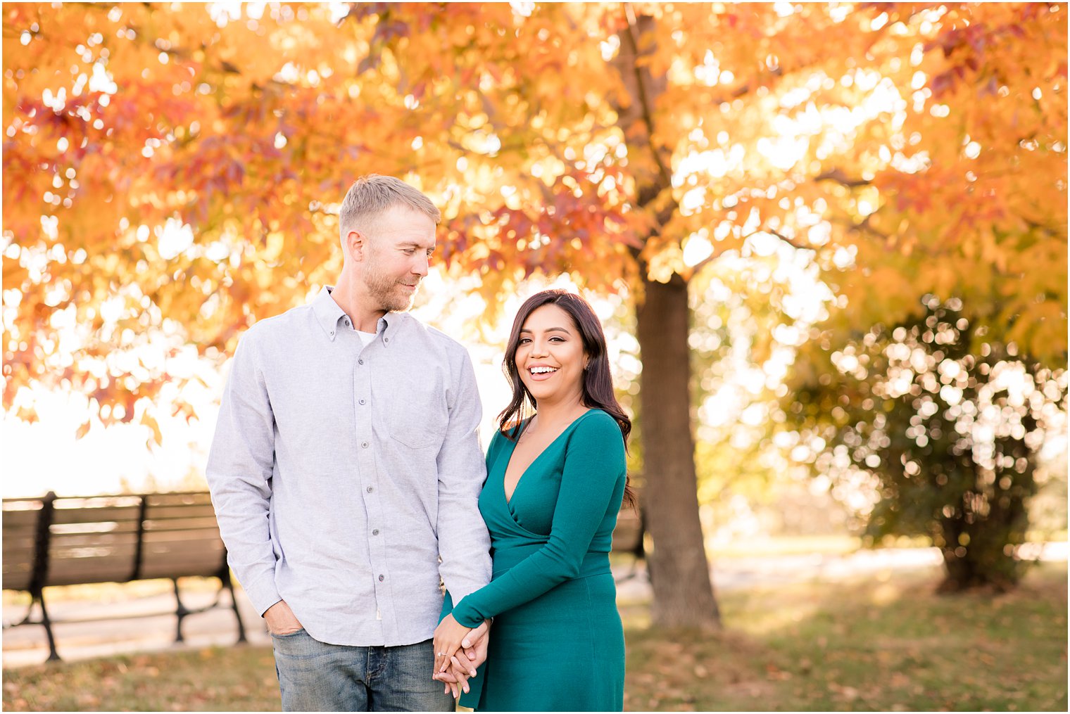 Bride and groom posing for engagement photos at Liberty State Park